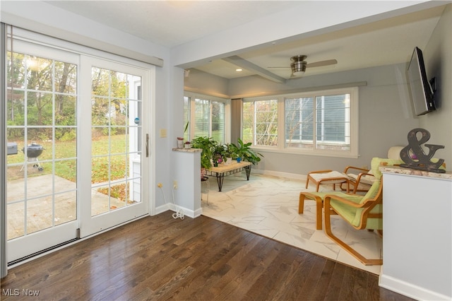 sunroom featuring ceiling fan