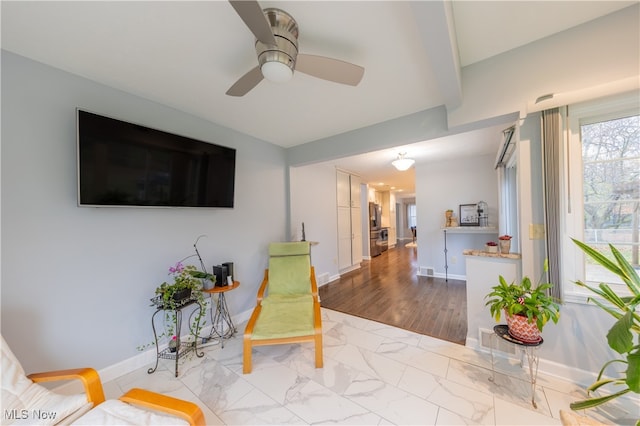 living area featuring ceiling fan and light hardwood / wood-style flooring