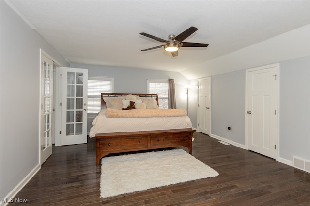 bedroom featuring ceiling fan, dark hardwood / wood-style flooring, and lofted ceiling