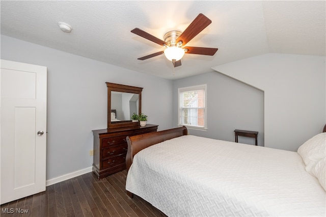 bedroom featuring a textured ceiling, ceiling fan, dark hardwood / wood-style flooring, and lofted ceiling