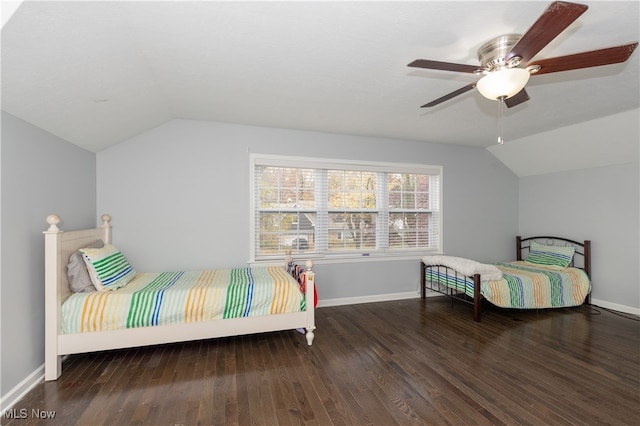 bedroom featuring ceiling fan, dark wood-type flooring, and lofted ceiling