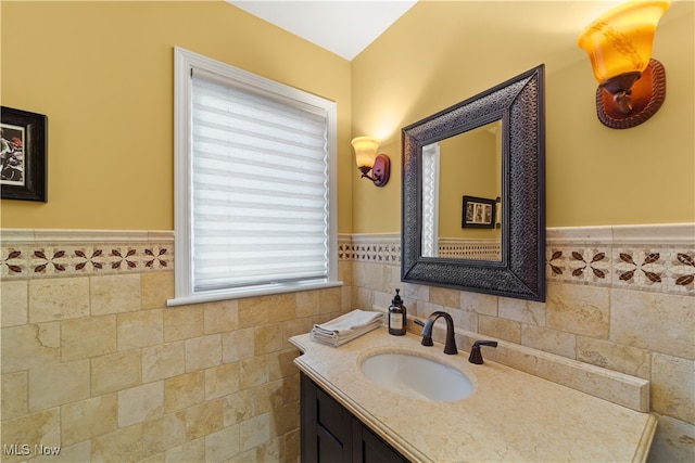 bathroom with plenty of natural light, vanity, and tile walls