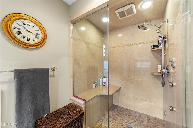 bathroom with a shower with door