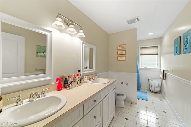 bathroom featuring tile patterned flooring, vanity, and toilet