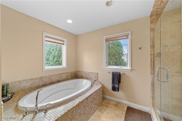 bathroom featuring tile patterned flooring, a healthy amount of sunlight, and separate shower and tub