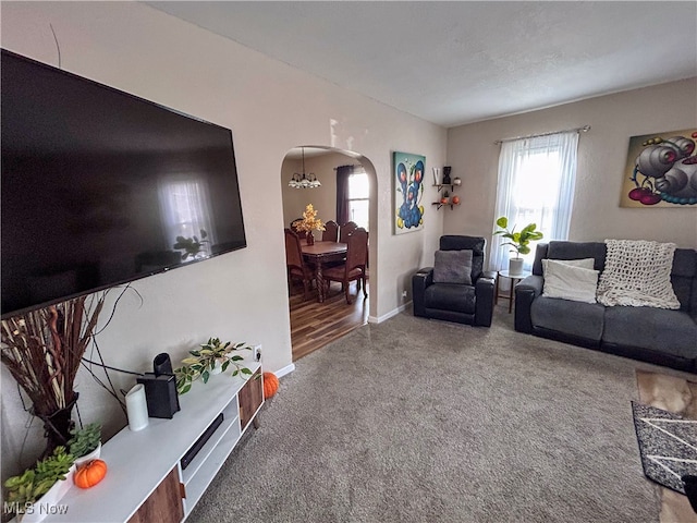 living room featuring carpet flooring and a notable chandelier