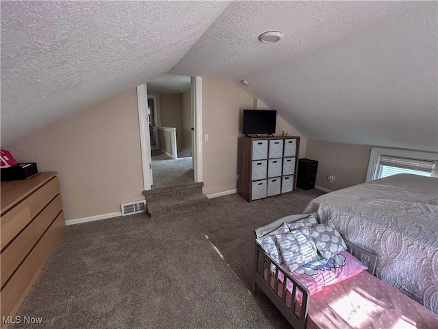 carpeted bedroom with a textured ceiling and lofted ceiling