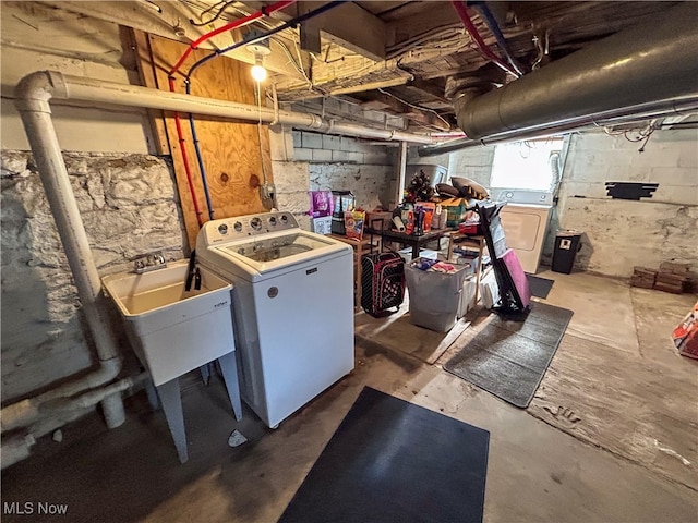 basement featuring washer and dryer and sink