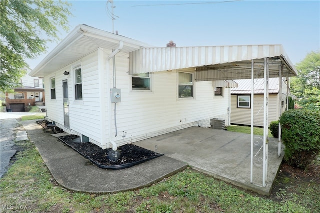 rear view of house with central air condition unit