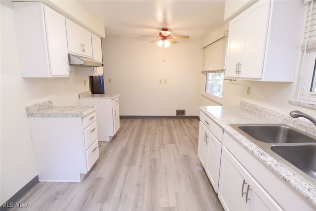 kitchen featuring white cabinets, ceiling fan, light hardwood / wood-style floors, and sink