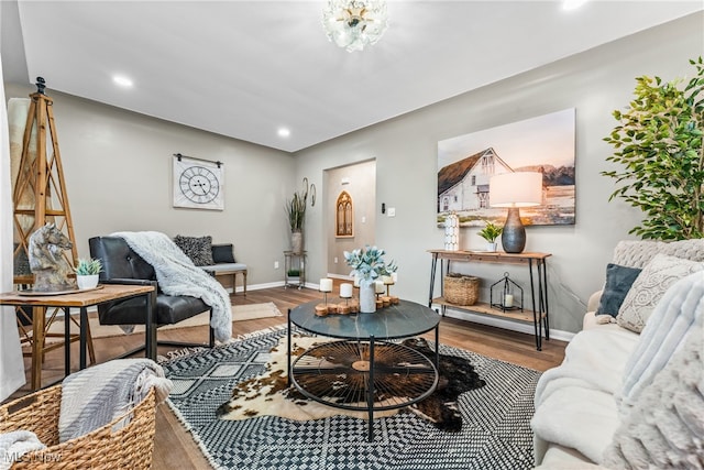 living room with hardwood / wood-style floors and an inviting chandelier