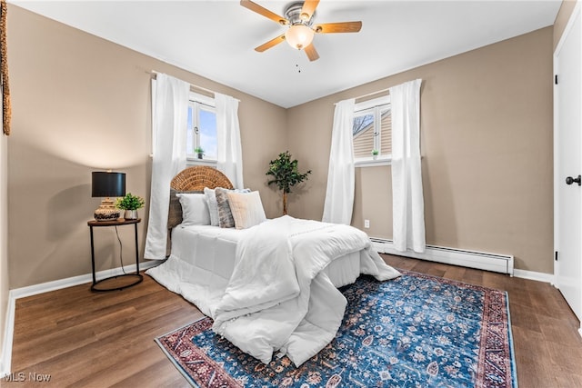 bedroom featuring ceiling fan, wood-type flooring, and baseboard heating