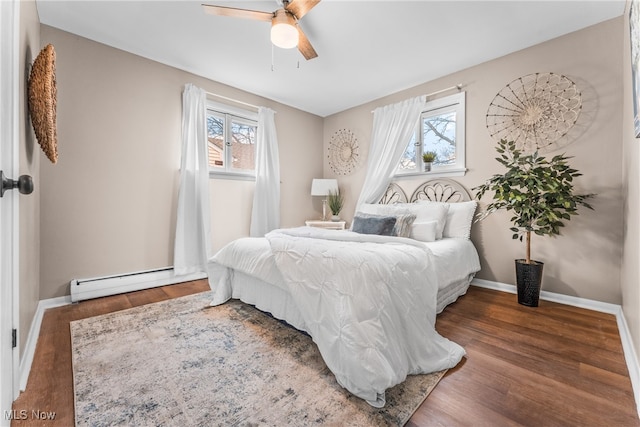 bedroom with a baseboard radiator, ceiling fan, and dark hardwood / wood-style floors