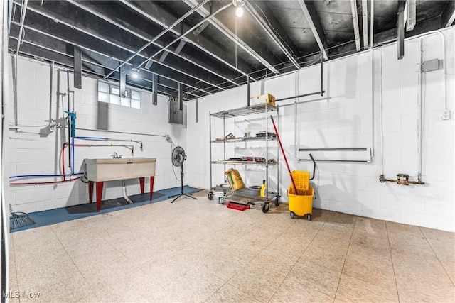 basement featuring electric panel and sink