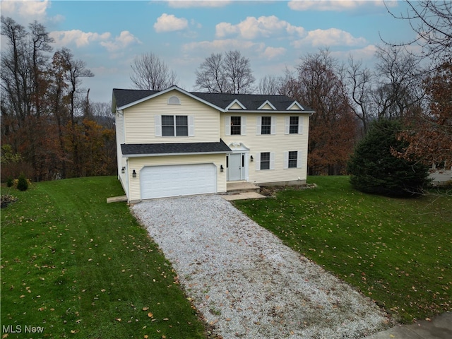 view of front of home with a front yard and a garage