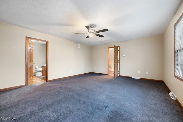 carpeted spare room with ceiling fan