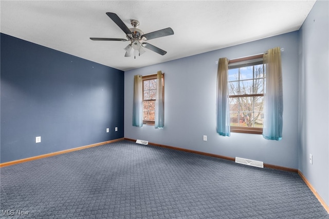 carpeted spare room with ceiling fan and a healthy amount of sunlight