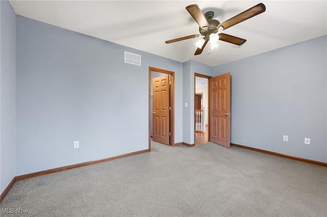 unfurnished bedroom with ceiling fan and light colored carpet