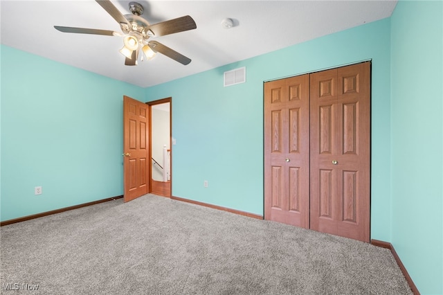 unfurnished bedroom featuring carpet flooring, ceiling fan, and a closet