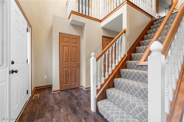 entryway featuring dark hardwood / wood-style flooring and a high ceiling