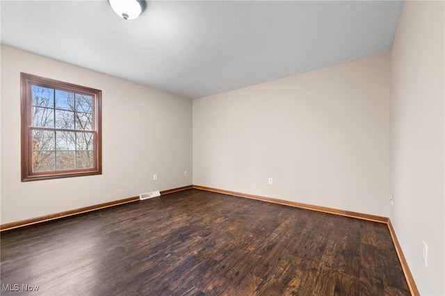 unfurnished room with dark hardwood / wood-style floors