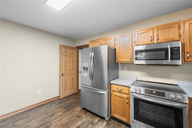 kitchen featuring stainless steel appliances and dark hardwood / wood-style floors