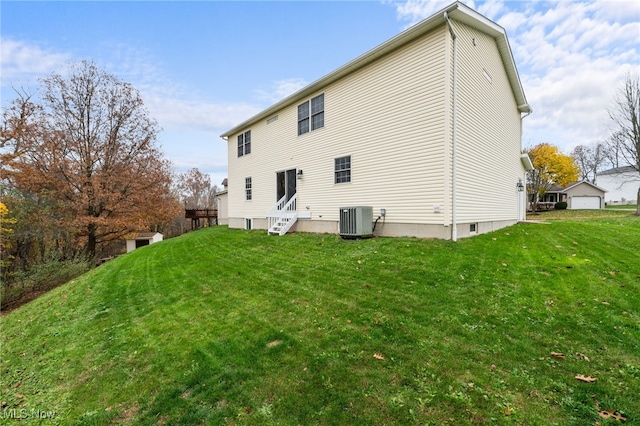 back of property featuring a lawn and cooling unit