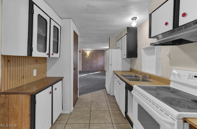 kitchen featuring white appliances, ventilation hood, sink, white cabinetry, and light tile patterned flooring