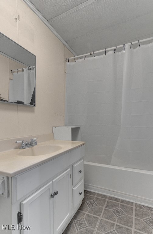 bathroom with tile patterned flooring, vanity, shower / bath combo, and a textured ceiling