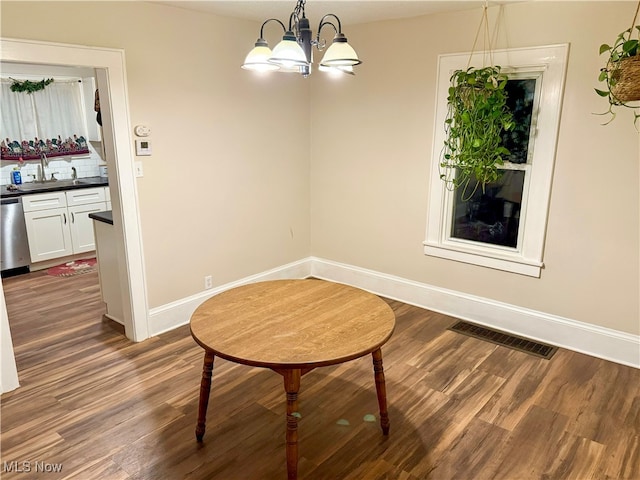 dining room featuring a notable chandelier and dark wood-type flooring