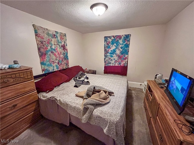 carpeted bedroom featuring a textured ceiling