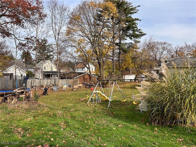 view of yard featuring a playground and a trampoline