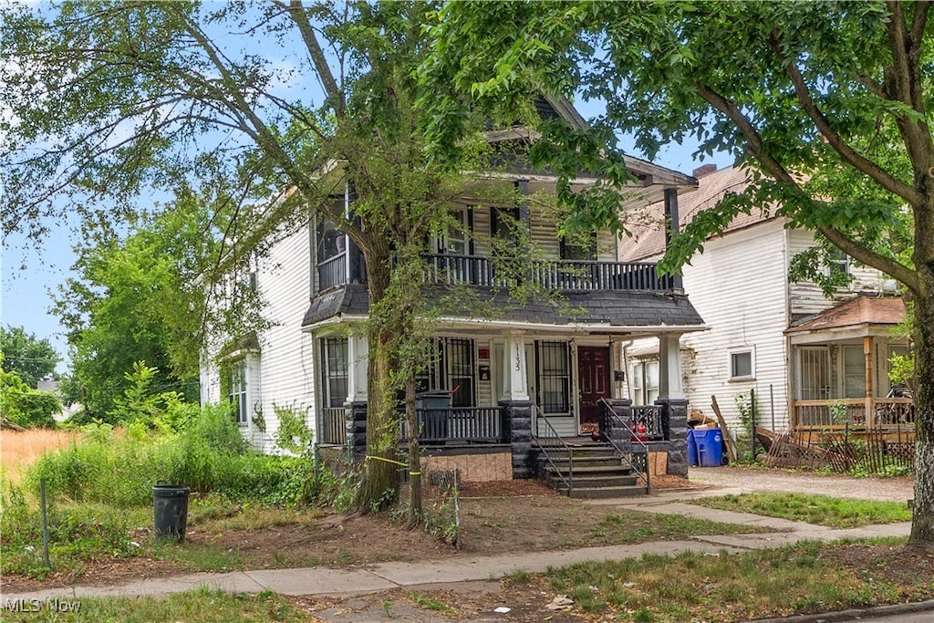 view of front of home featuring a balcony and a porch