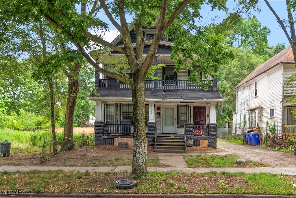 view of front of property with a porch and a balcony