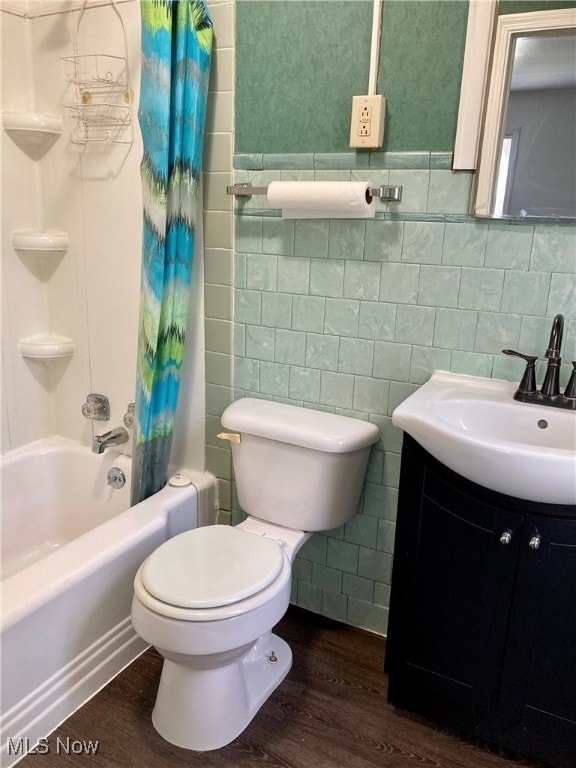 full bathroom with hardwood / wood-style flooring, shower / tub combo with curtain, and tile walls