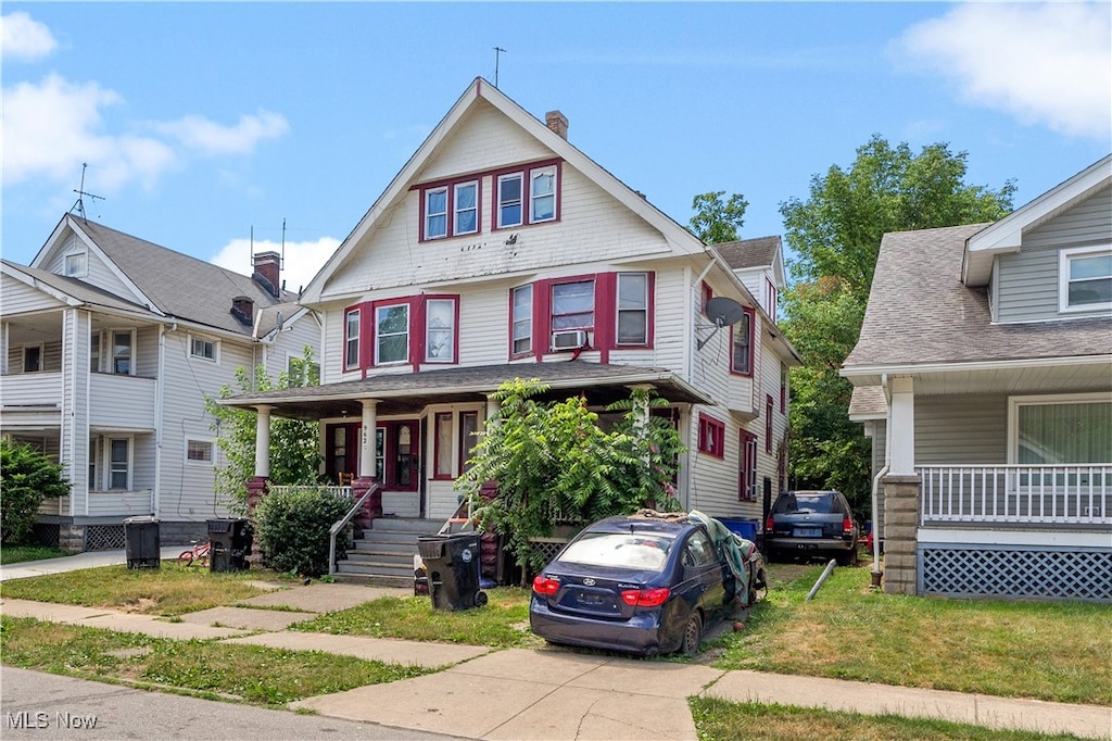 view of front of property with covered porch and central AC unit