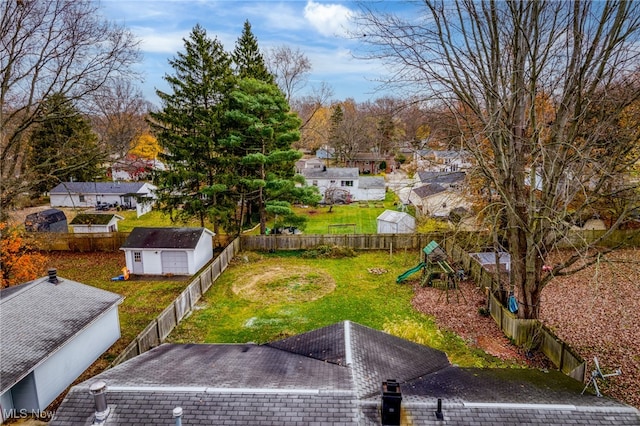 view of yard featuring a playground and a storage unit