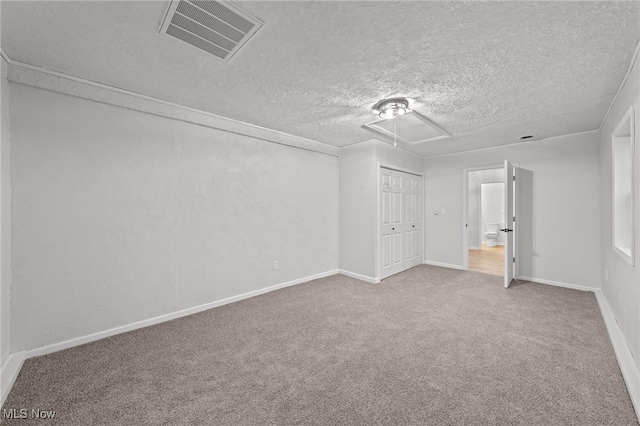 unfurnished bedroom with a closet, carpet floors, and a textured ceiling