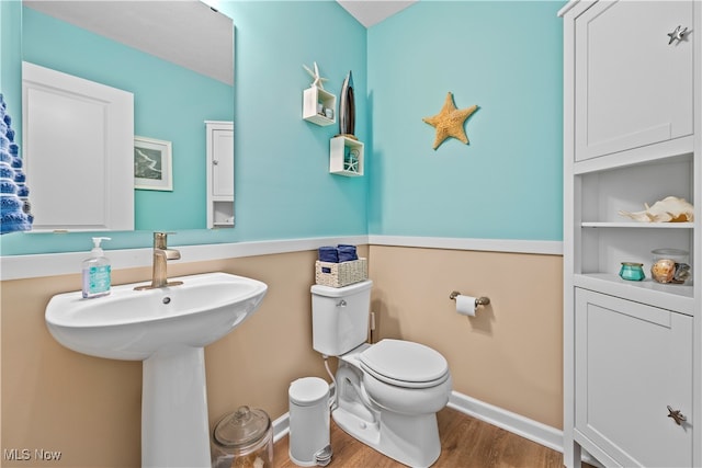 bathroom featuring hardwood / wood-style floors and toilet