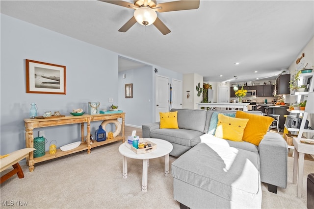 living room with light carpet and ceiling fan