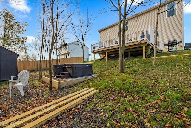 view of yard with a deck and a hot tub