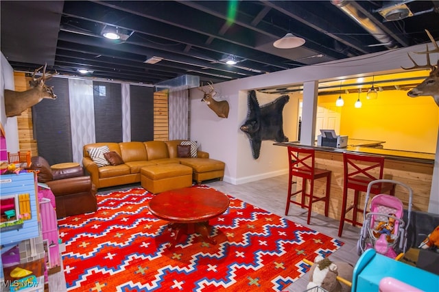 basement featuring bar area and hardwood / wood-style floors