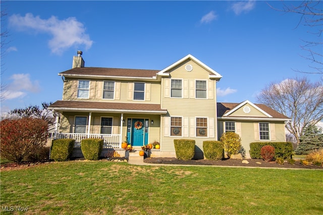 colonial inspired home with a porch and a front yard