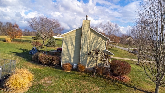 view of side of home with a lawn