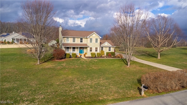 colonial inspired home with a porch and a front lawn