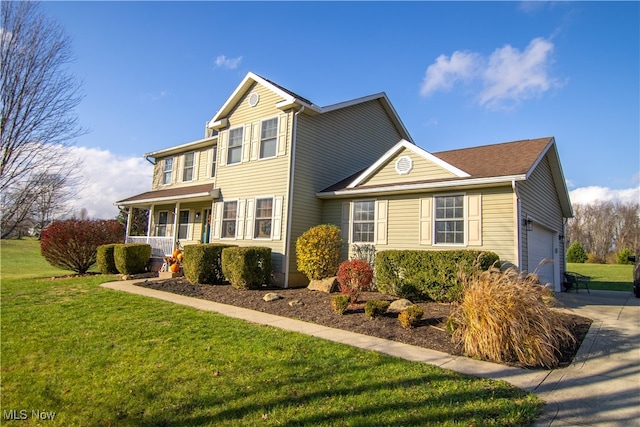 view of property with a front lawn, covered porch, and a garage