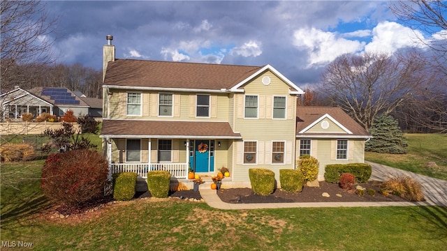 view of front of home featuring covered porch and a front lawn