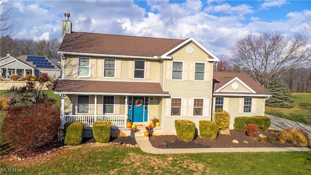 view of front of house with a porch and a front lawn