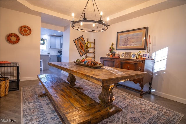 dining area featuring dark hardwood / wood-style flooring and a notable chandelier