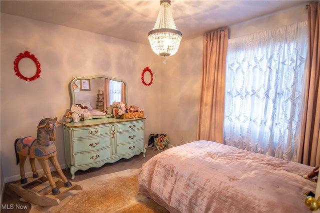 bedroom with carpet flooring and an inviting chandelier